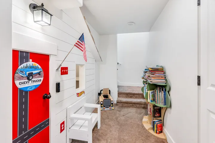 Custom built-in structure featuring horizontal paneling and a red door