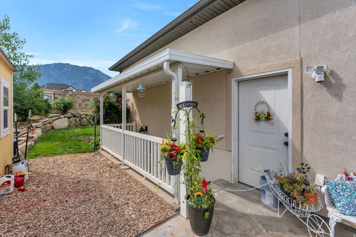Rear patio with stucco exterior and covered porch