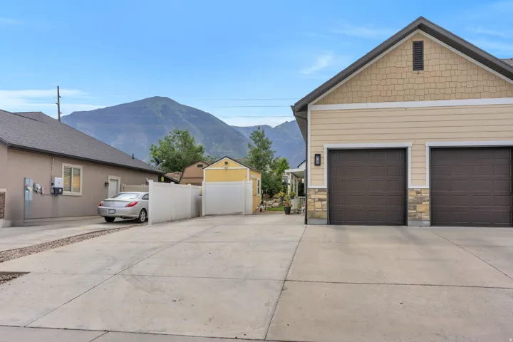 Multi-car driveway with concrete paving and gravel accents