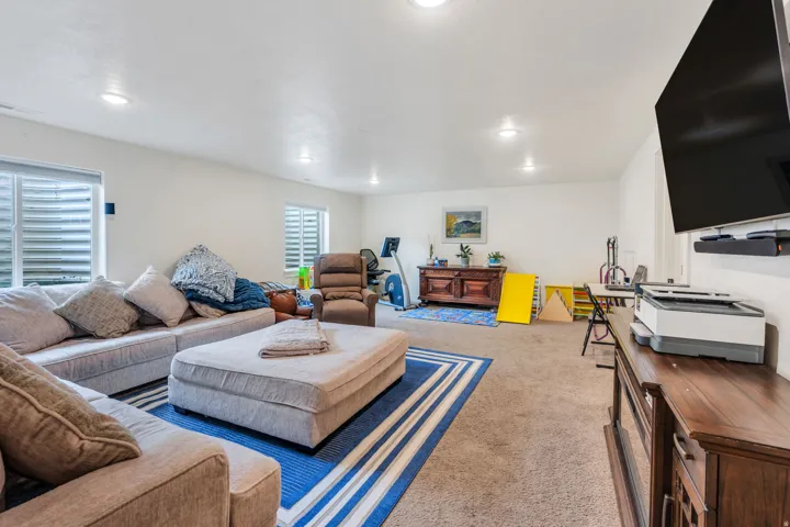Spacious room with carpeted flooring, recessed lighting, and white walls
