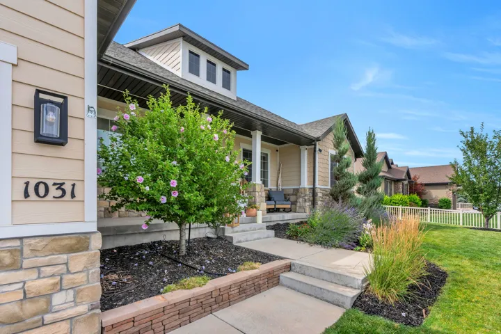 Crafted exterior featuring horizontal siding, stone accents, and a covered porch
