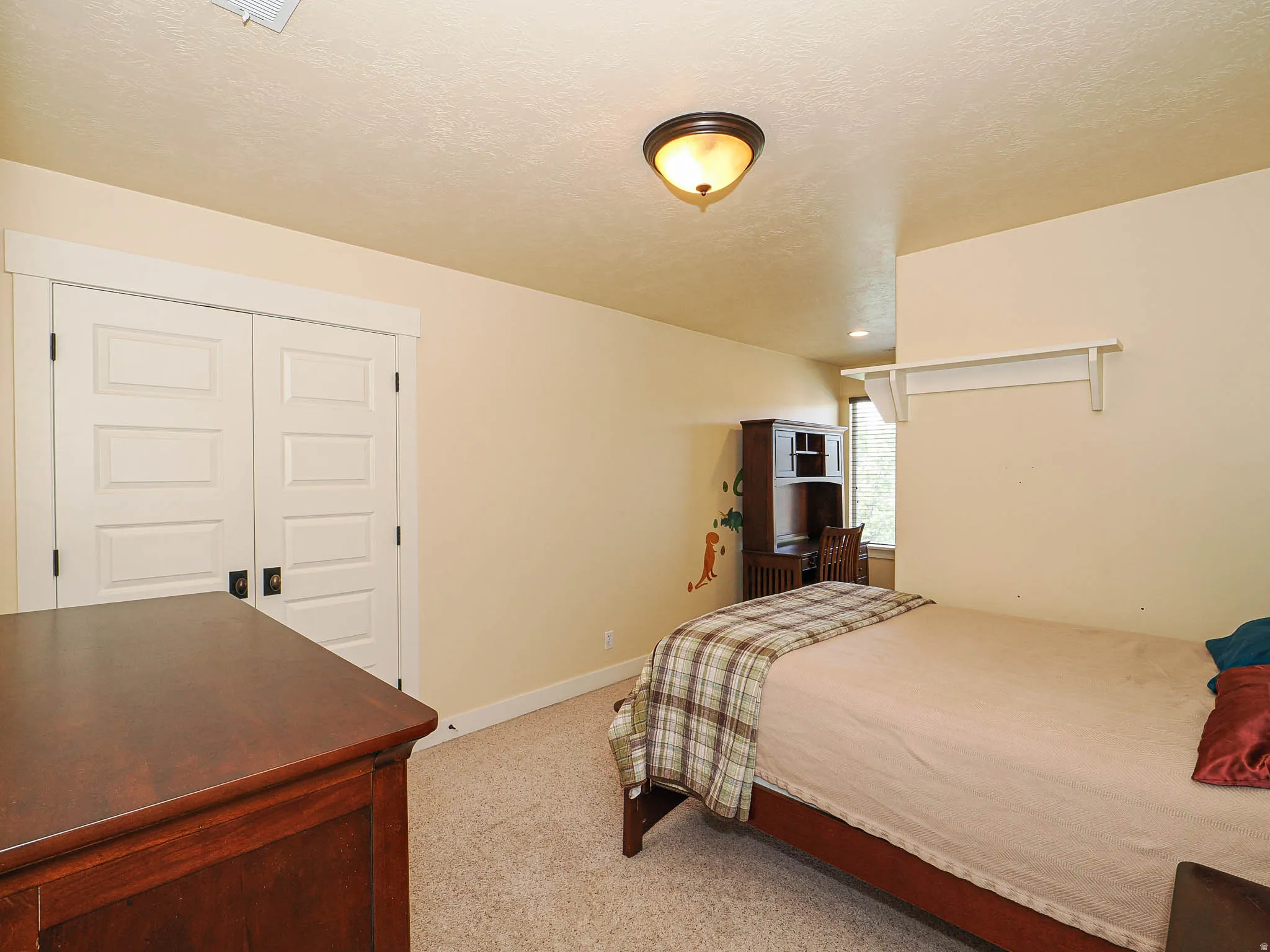 Room featuring light-toned walls and neutral carpet flooring