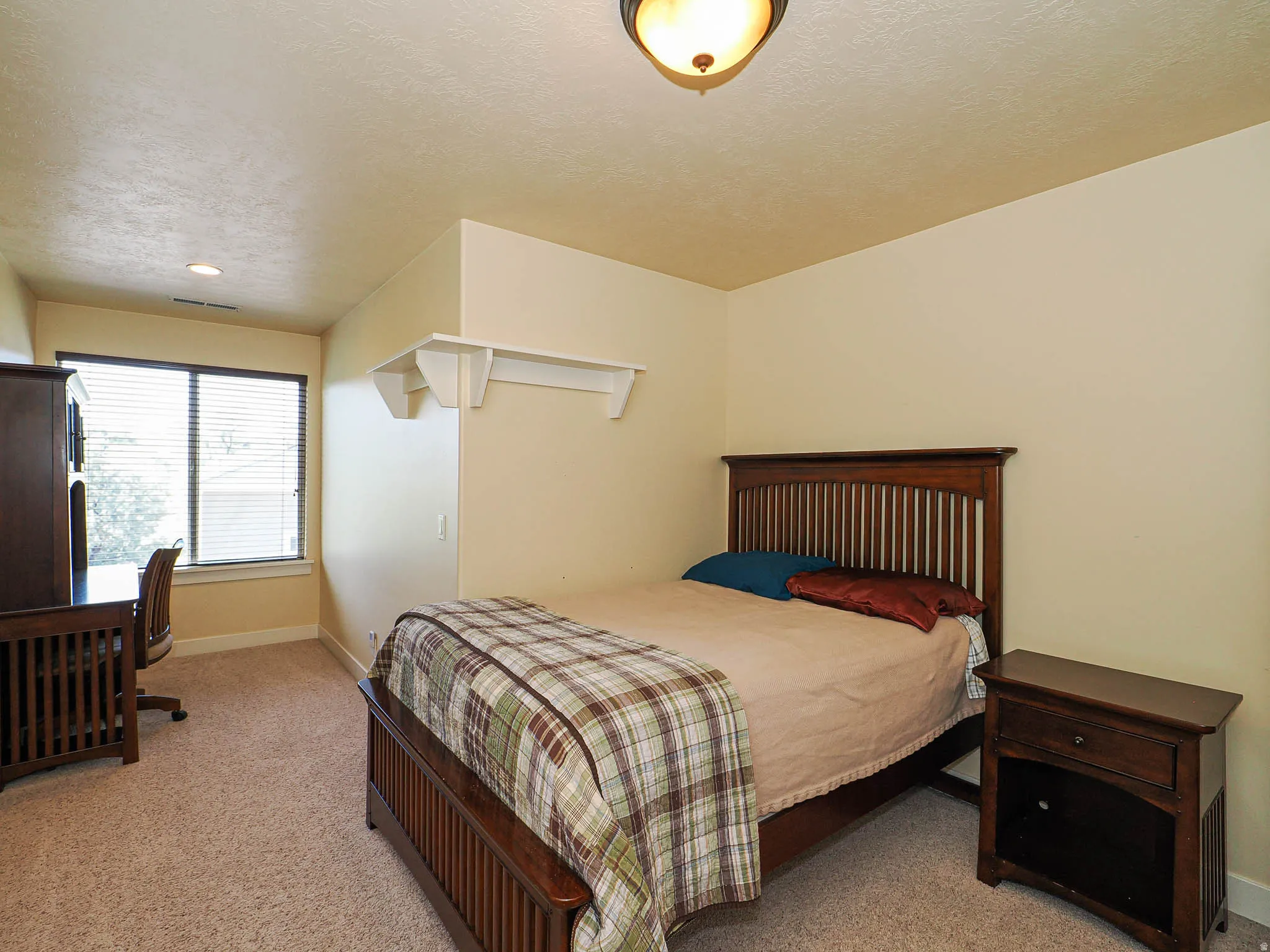 Carpeted room featuring a window with blinds, recessed lighting, and a flush mount ceiling fixture