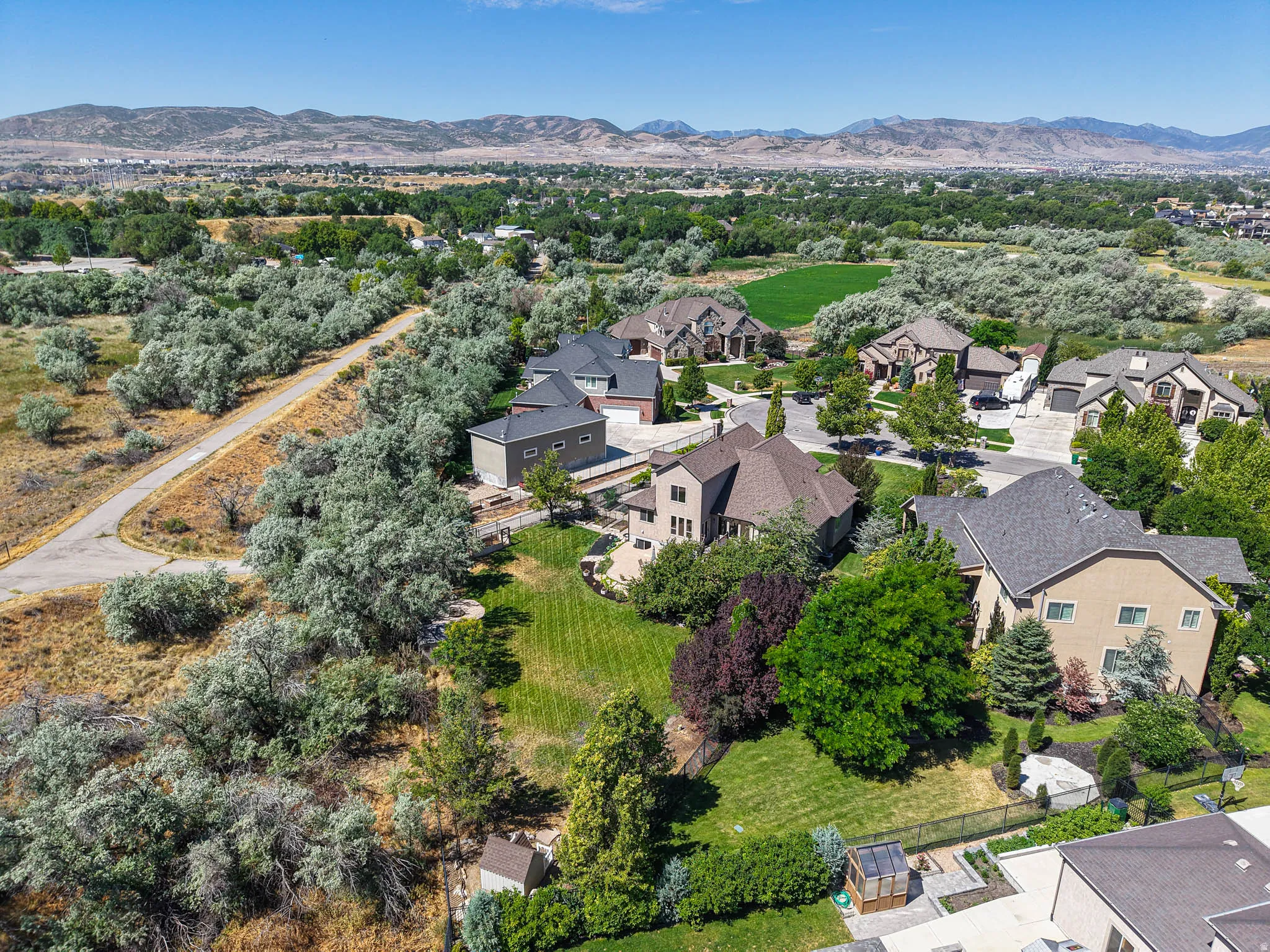 Spacious property featuring a large backyard with manicured lawns and mature trees