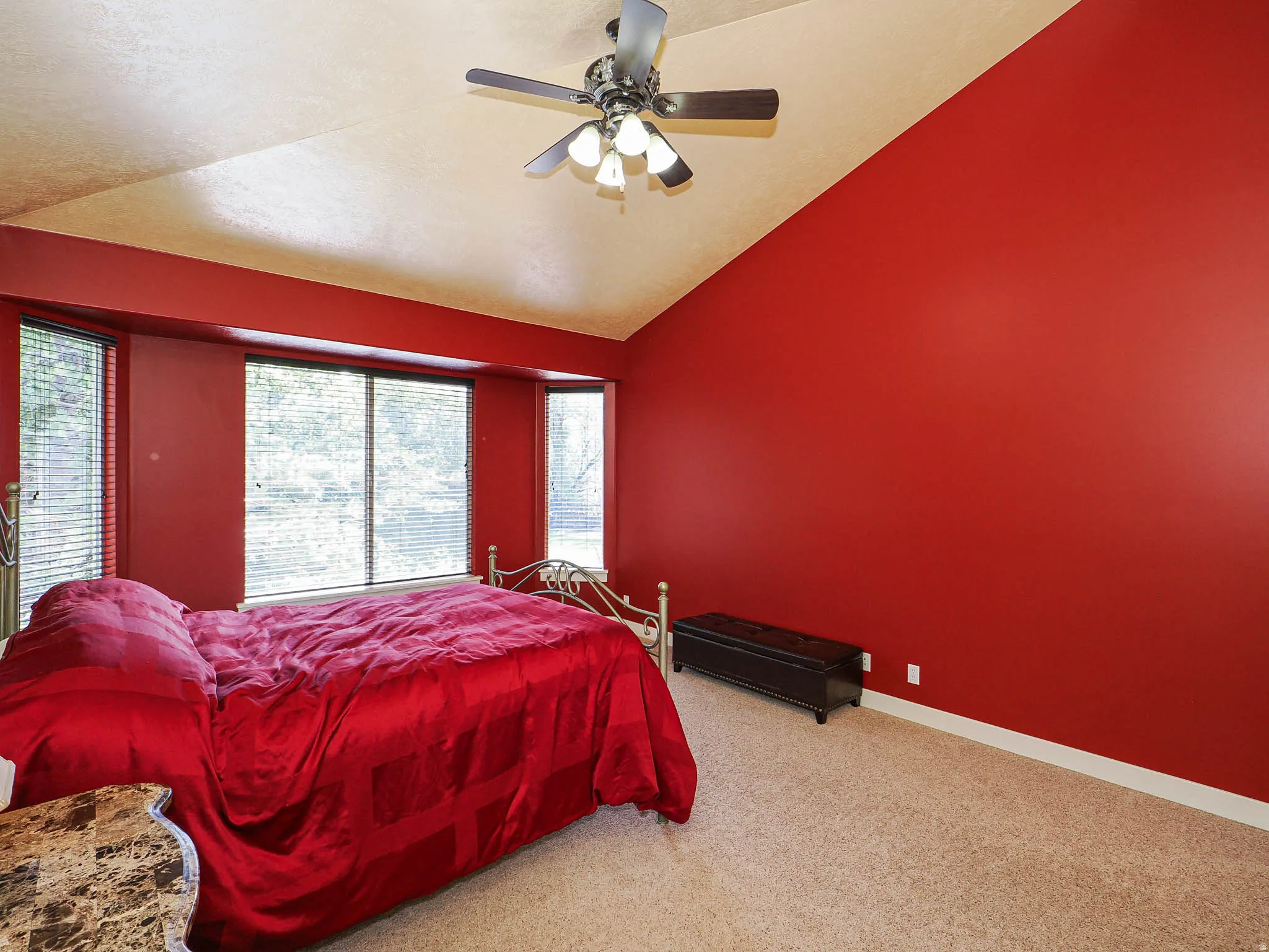 Vaulted ceilings featuring a ceiling fan with light fixture