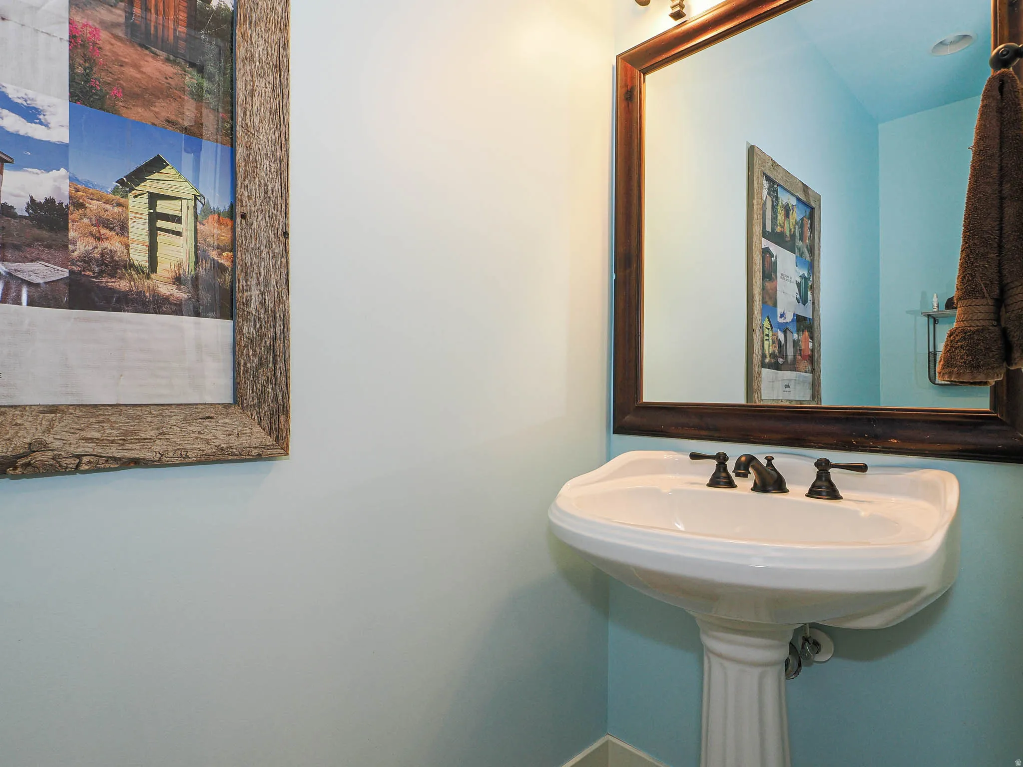 Pedestal sink with a three-piece bronze faucet