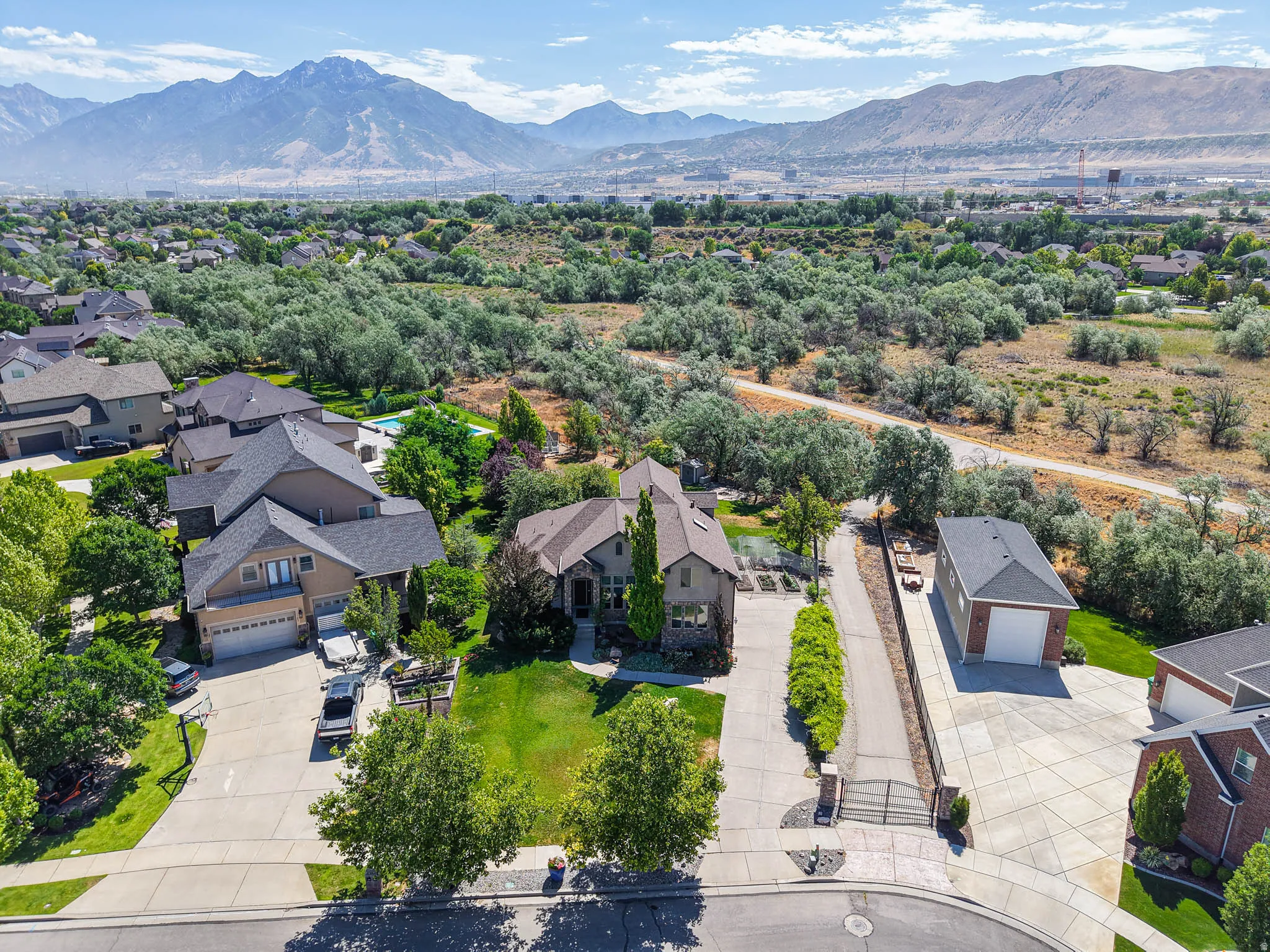 Custom-built residence featuring a spacious lot, mature landscaping, and a three-car garage