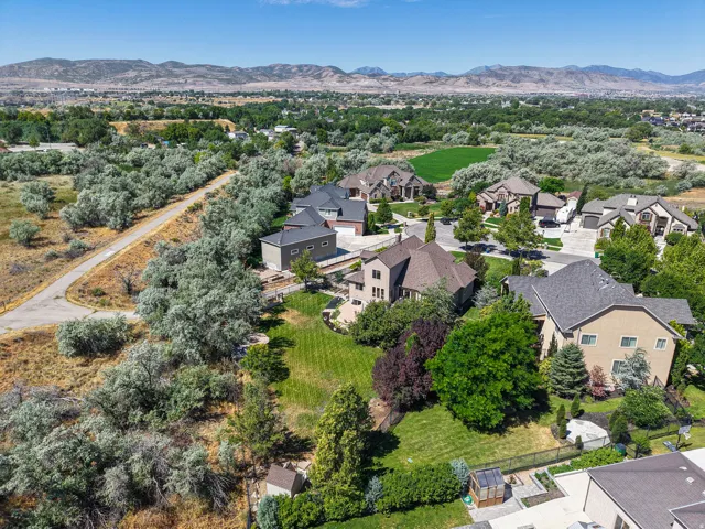 Spacious property featuring a large backyard with manicured lawns and mature trees