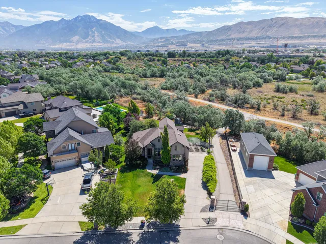 Custom-built residence featuring a spacious lot, mature landscaping, and a three-car garage