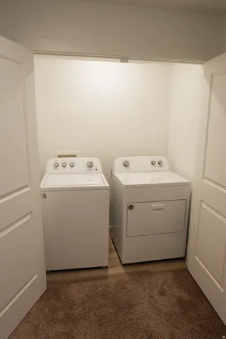 Dedicated laundry closet with wood-finish flooring
