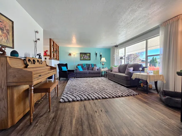Spacious interior featuring wood-finish flooring and a large picture window