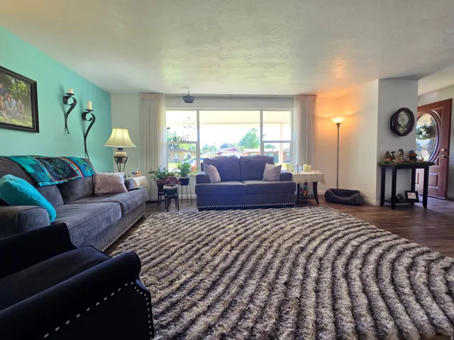 Spacious living area featuring expansive front-facing windows