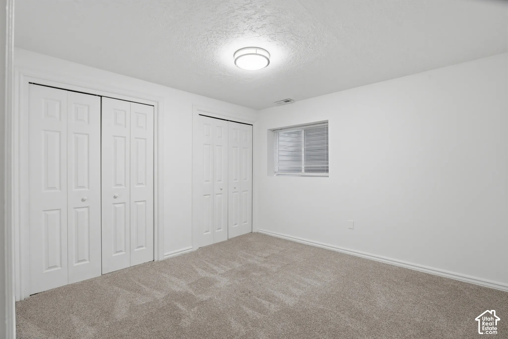 Neutral-toned carpeting paired with white walls