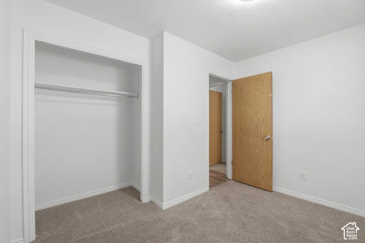 Room featuring neutral-toned carpeting and white walls