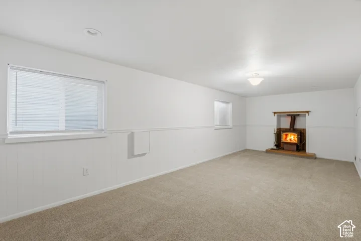 Spacious room with plush carpet flooring and white wainscoting