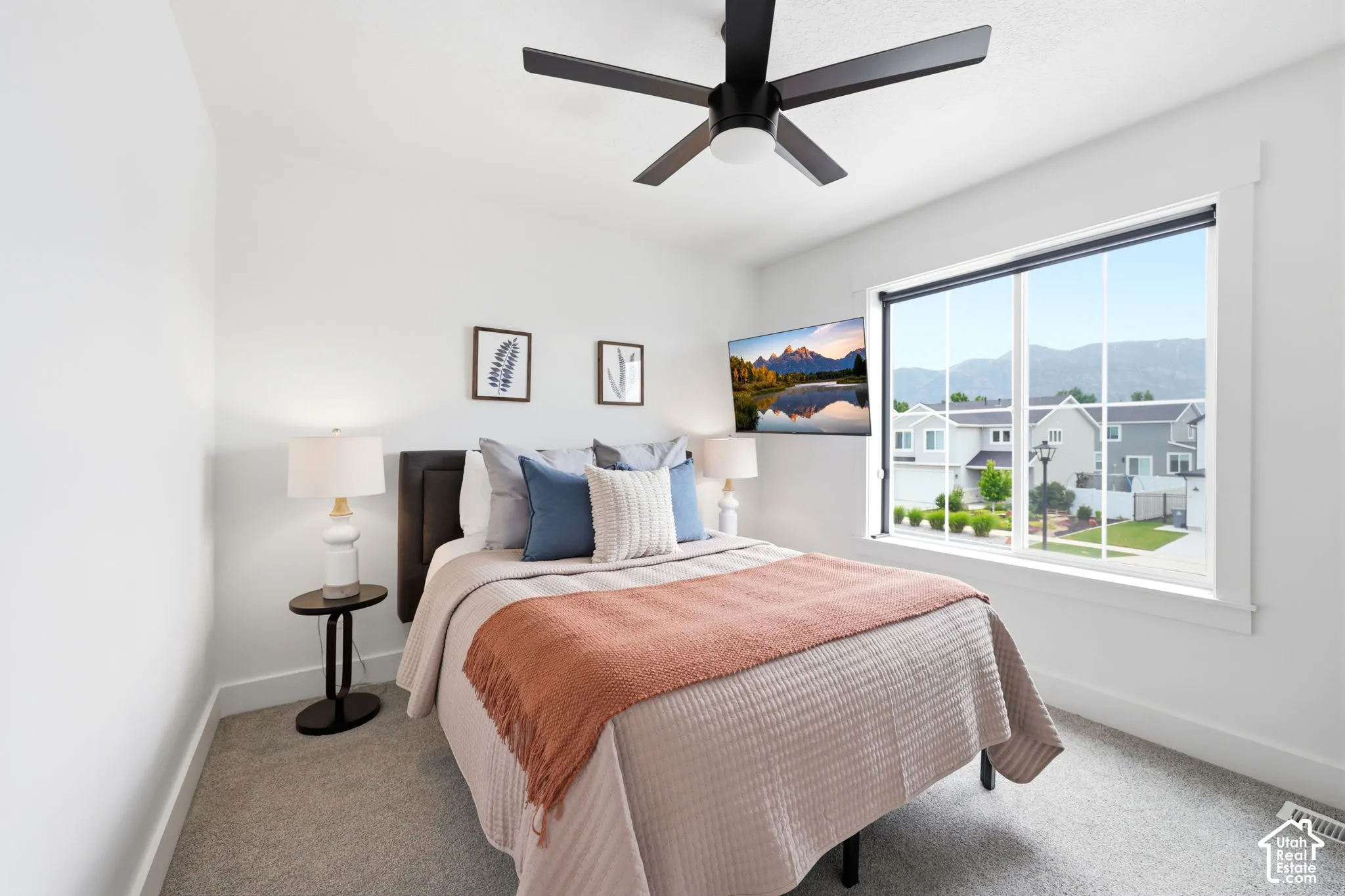 Bright bedroom with a large window and mountain scenery