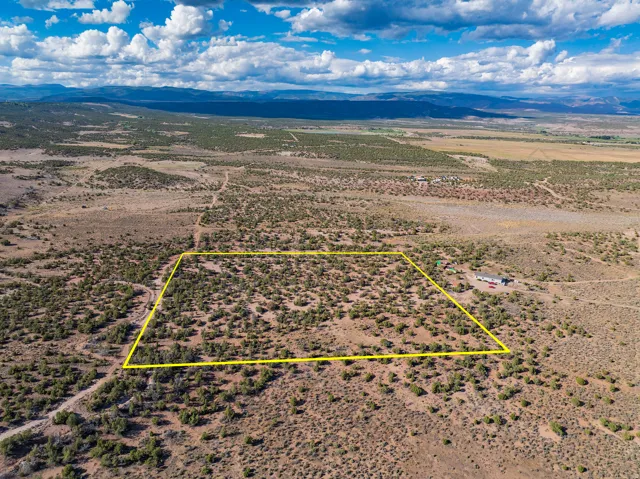 Expansive desert property with a natural landscape, bordered by distant mountains