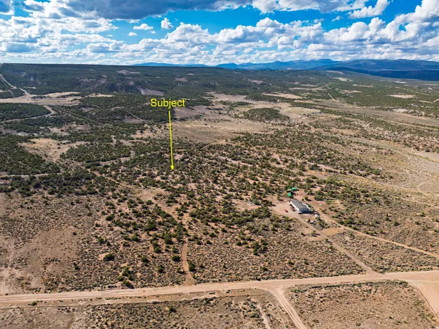 Expansive undeveloped land with a distant mountain range backdrop