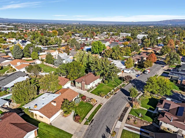 Aerial community overview featuring a network of residential properties and tree-lined streets
