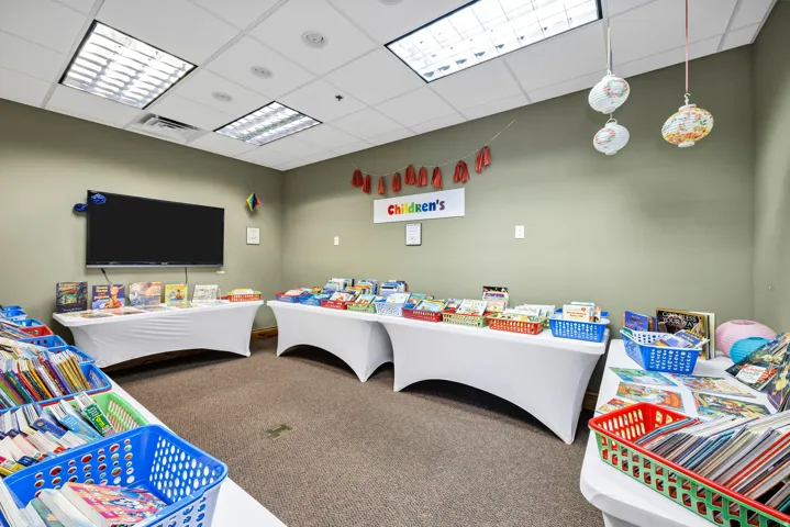 Spacious room featuring recessed lighting, ceiling-mounted fluorescent lights, and carpeted flooring