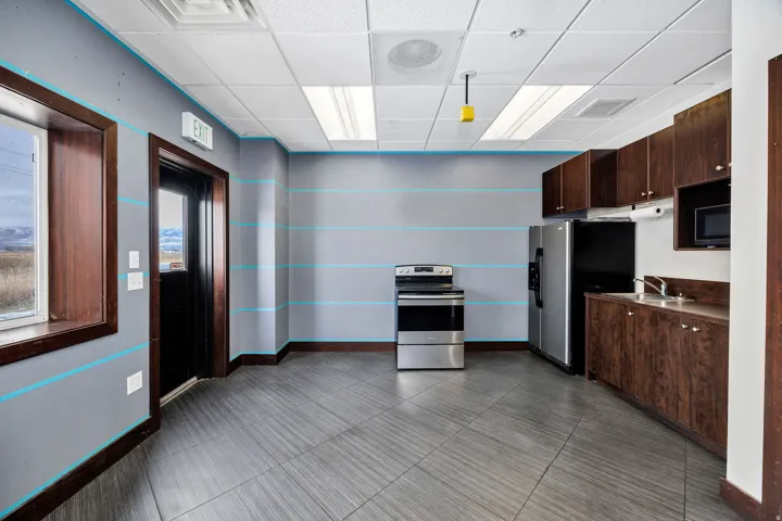 Kitchenette featuring wood-finish cabinetry, stainless steel appliances, and a built-in microwave