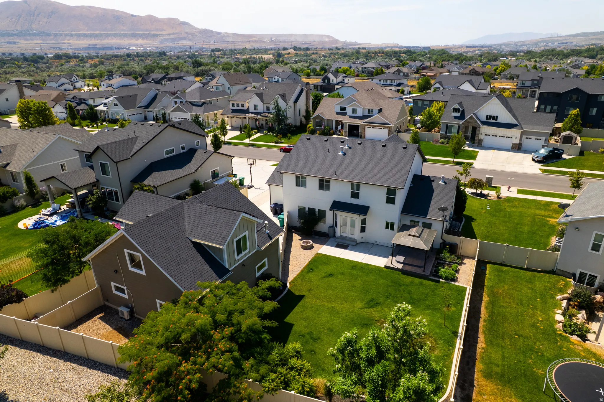 Spacious backyard featuring a manicured lawn, established perimeter fencing, and a dedicated patio area