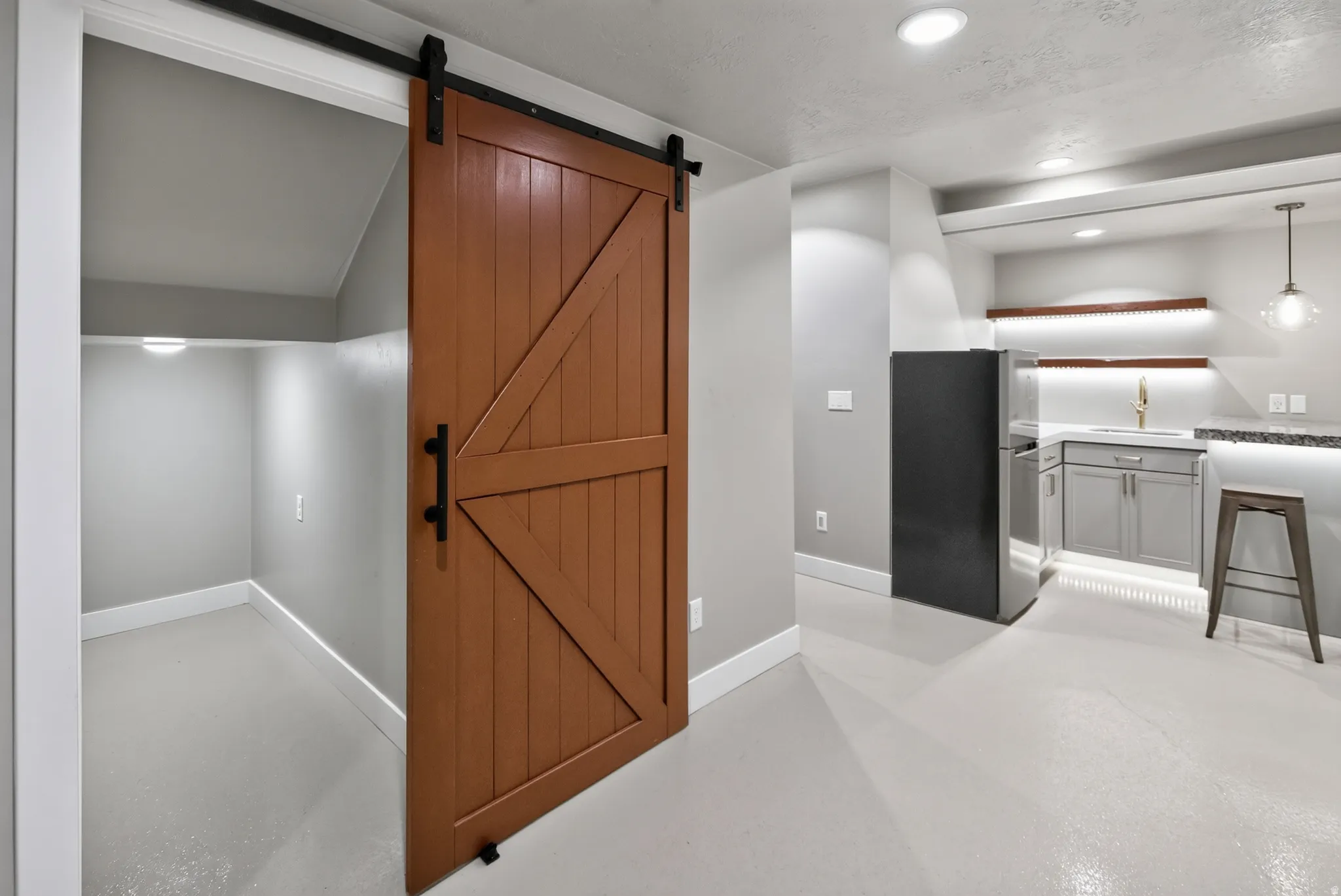 Warm wood-finish barn door opens to a practical storage area