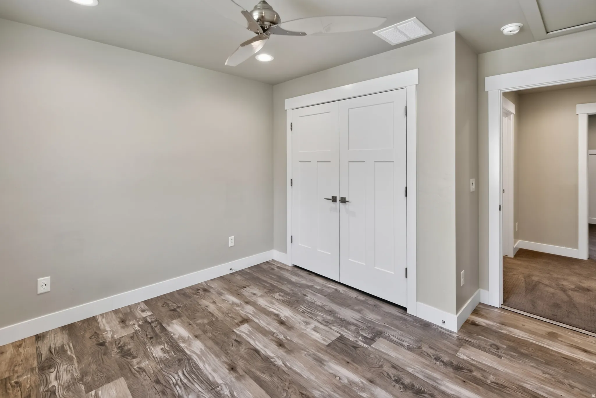 Interior room featuring wood-finish flooring and light-toned walls