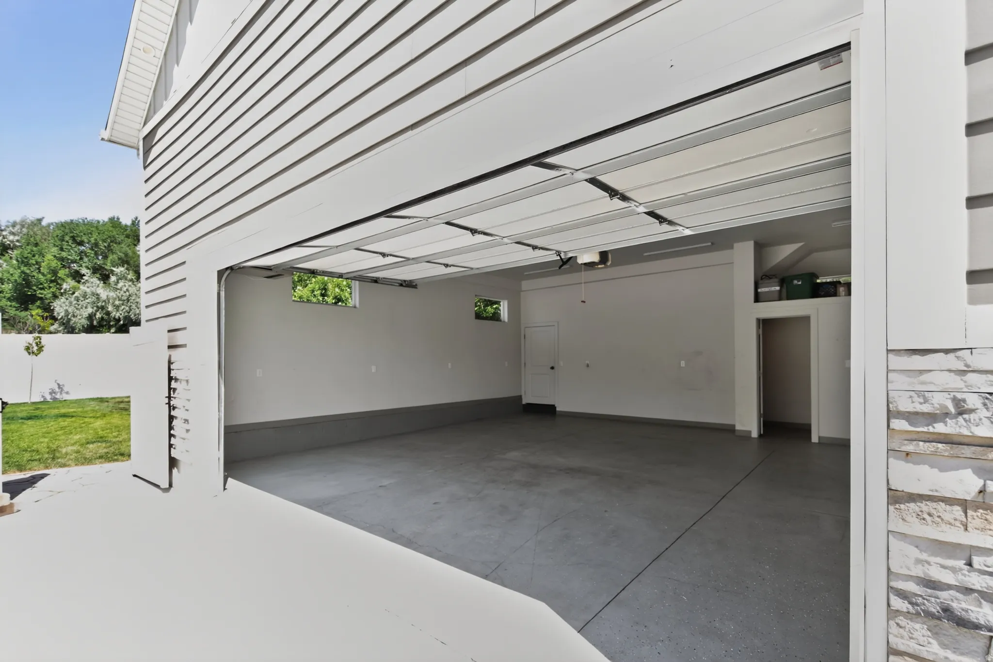 Spacious two-car garage with concrete flooring and light gray walls