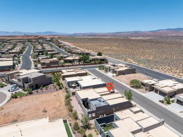Modern residential development featuring flat-roofed homes and desert landscaping