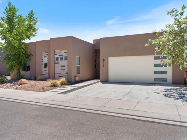Contemporary stucco exterior featuring decorative stone accents