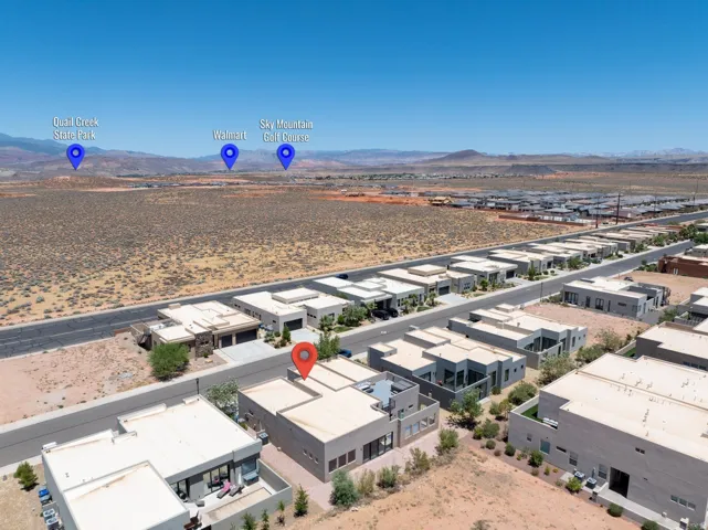 Aerial perspective showcasing a modern single-story residence with a flat roof design