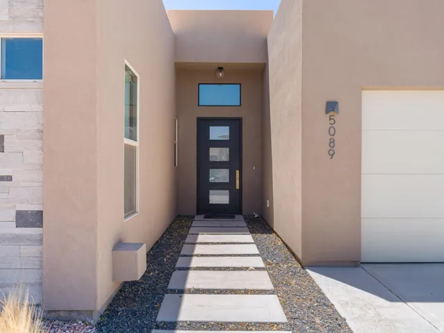 Contemporary exterior featuring stucco and stacked stone accents