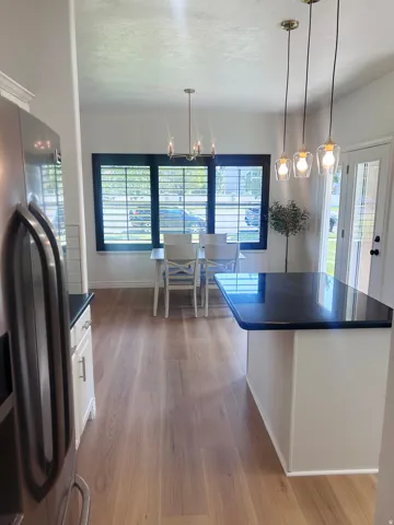 Wood-finish flooring throughout, complemented by a built-in island with a dark countertop