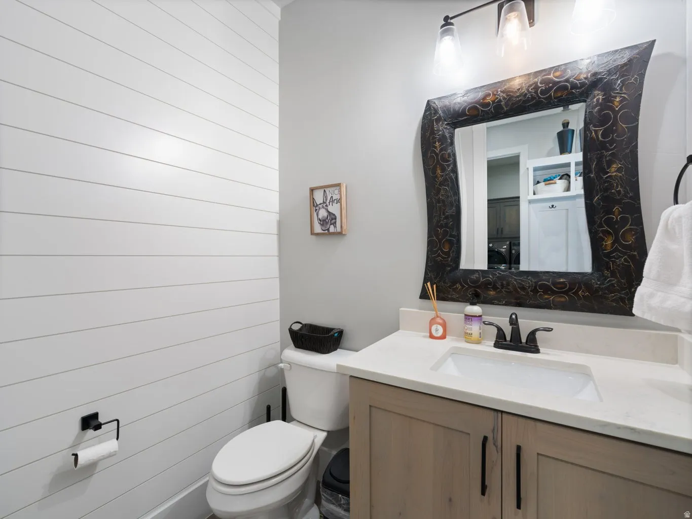 Vanity featuring a light-toned countertop, undermount sink, and dark-toned faucet
