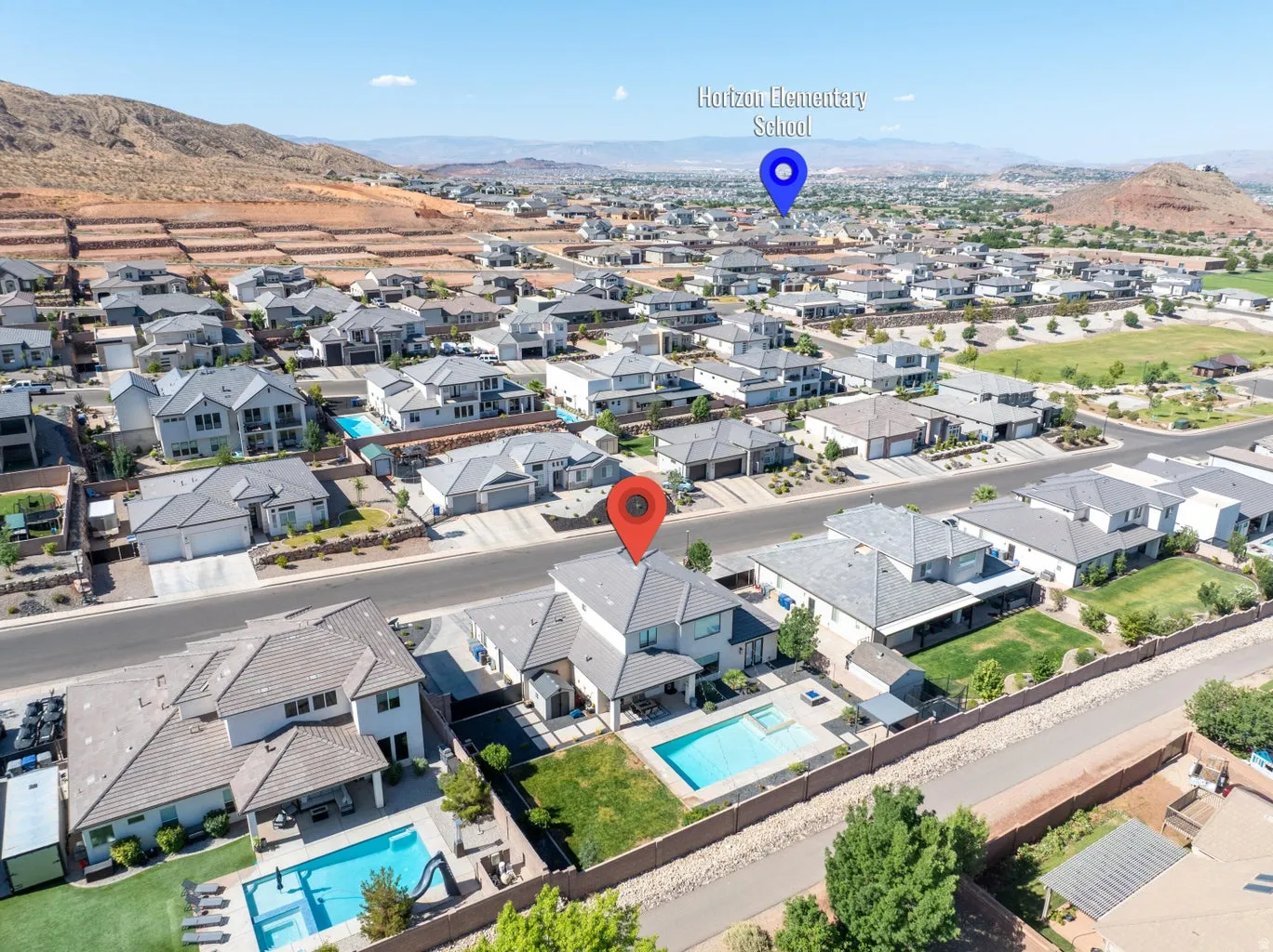 Expansive residential neighborhood featuring numerous properties with private swimming pools and surrounding mountainous terrain