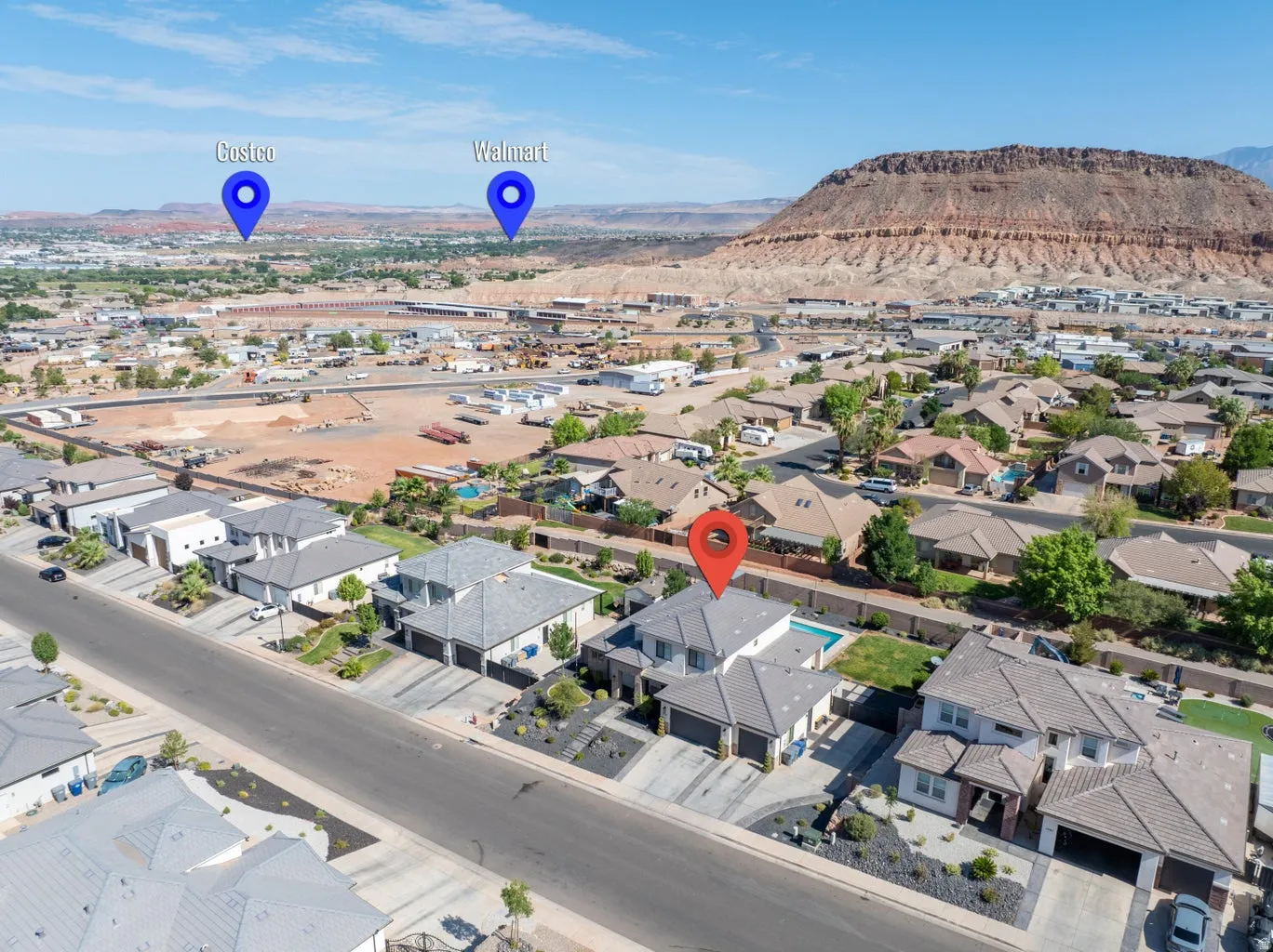 Aerial perspective showcasing a residential neighborhood with distant mountain formations