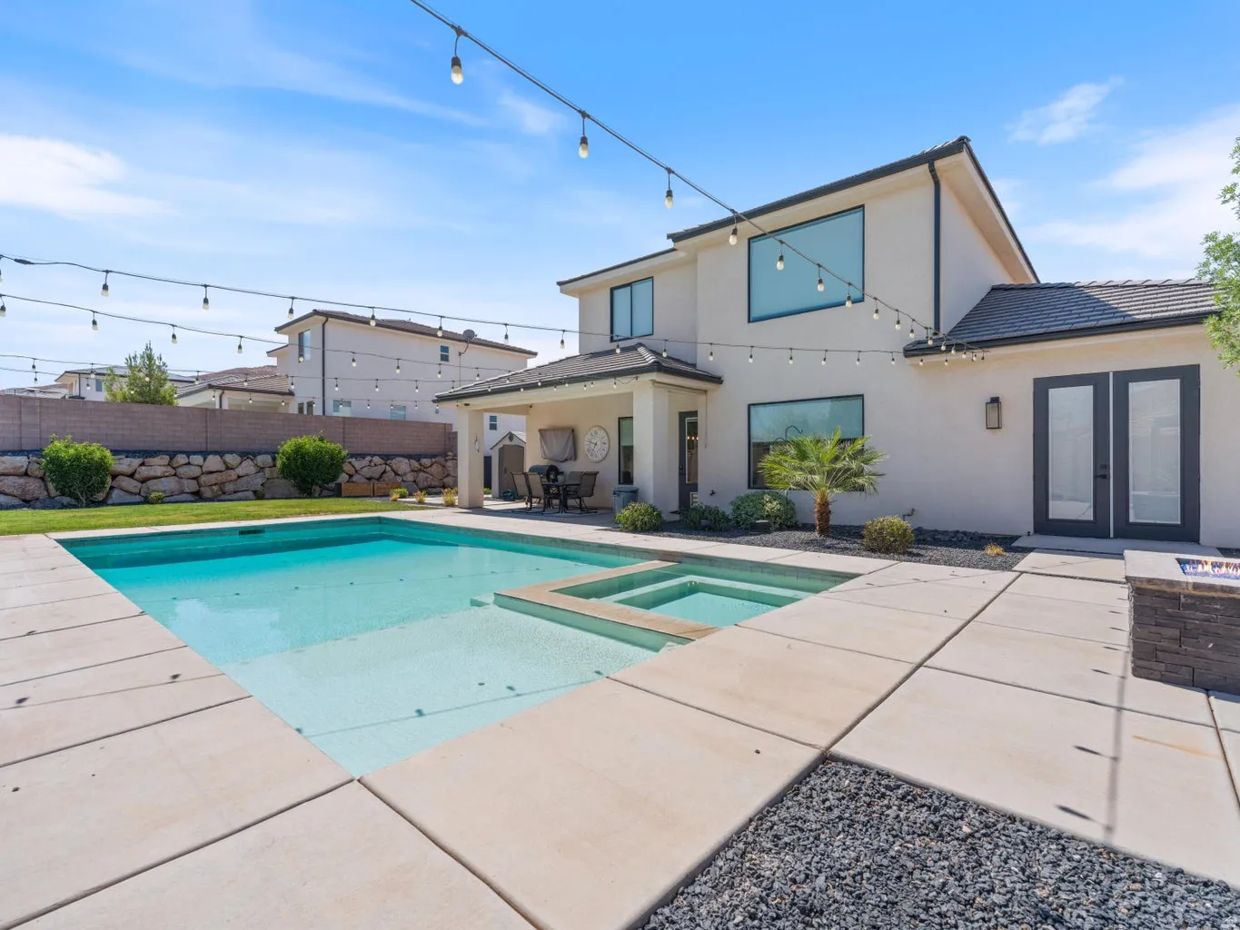 Backyard oasis featuring a swimming pool, integrated spa, and concrete patio