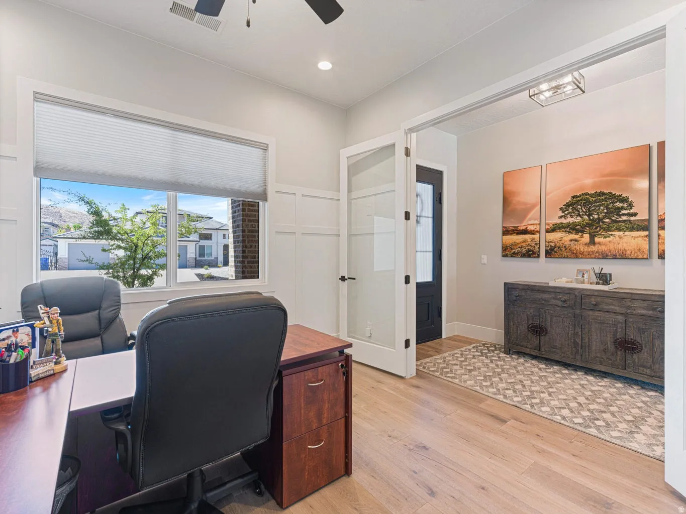 Light wood-finish flooring complements the neutral wall color in this versatile room