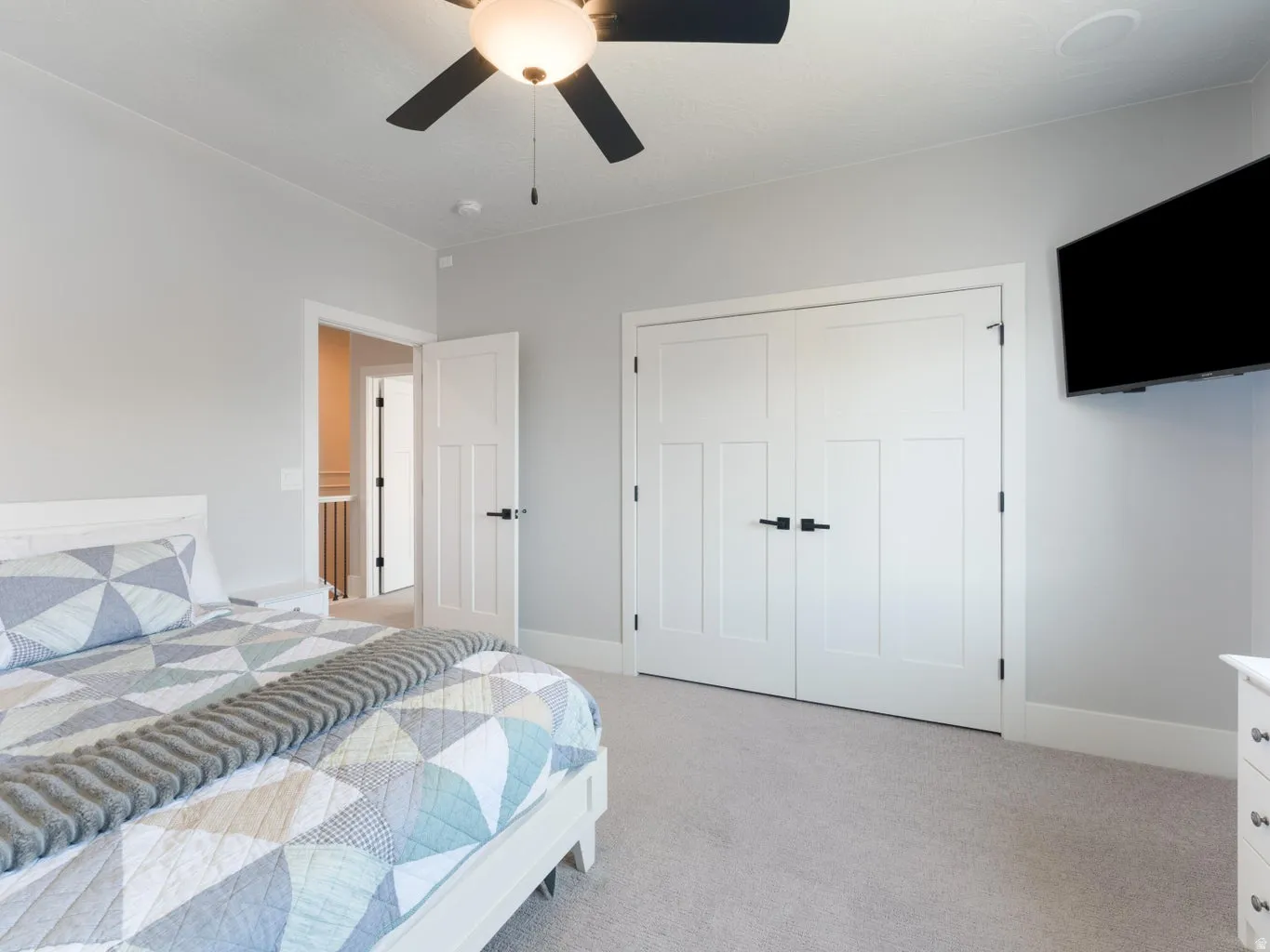 Neutral tone walls with light-colored carpet flooring
