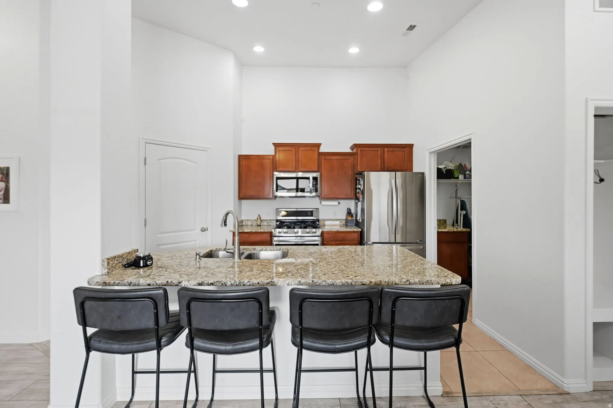 Kitchen island with a granite countertop and an undermount sink