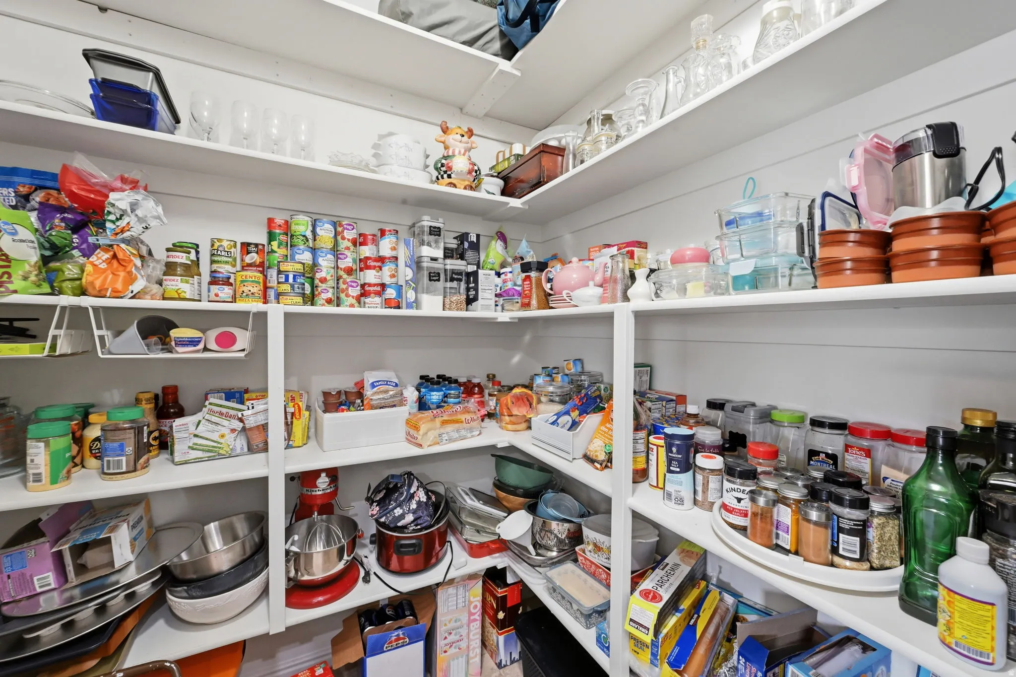Built-in pantry shelving featuring white painted wood construction