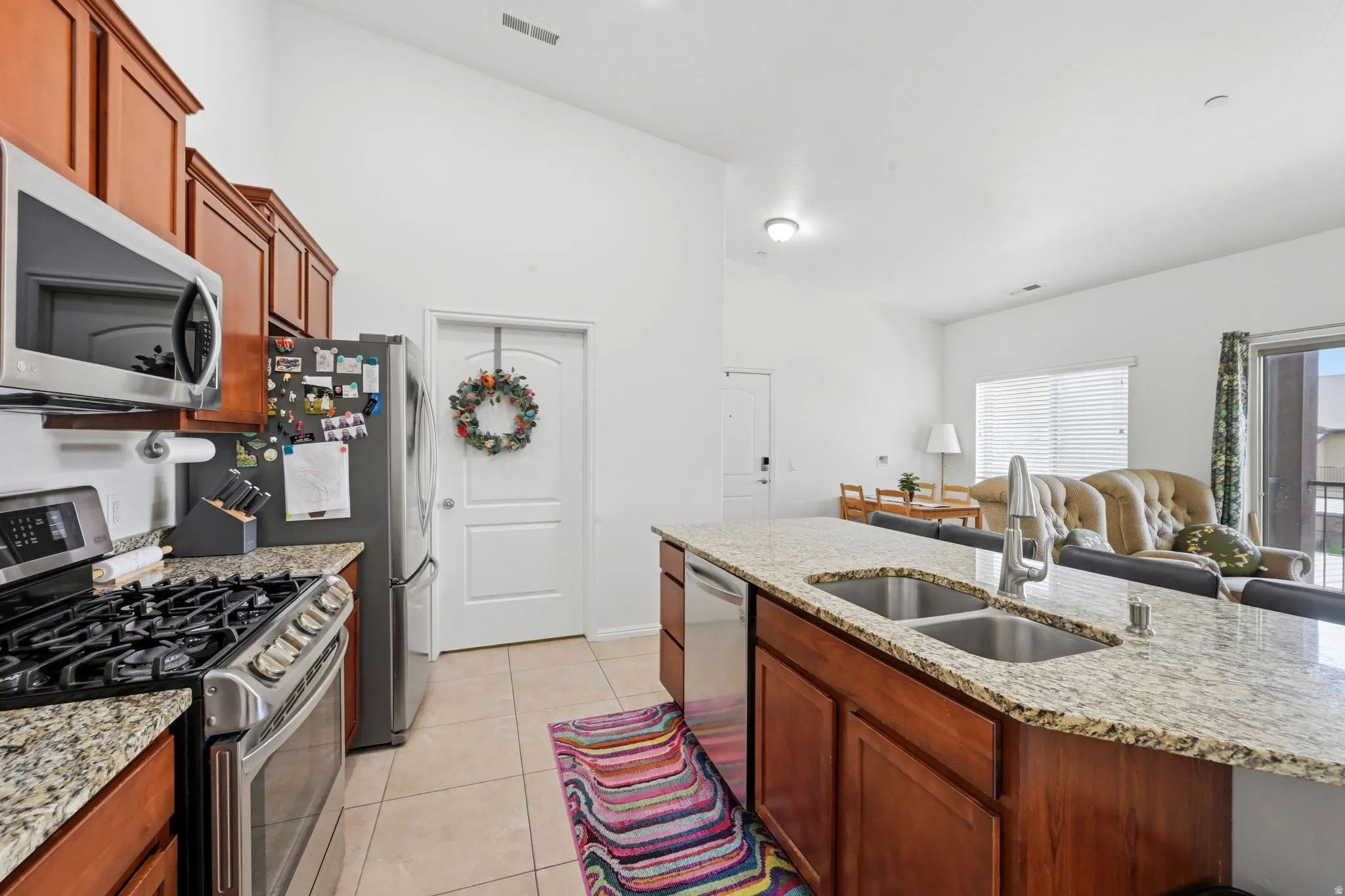 Kitchen featuring wood cabinetry, stainless steel appliances, and light-toned countertops