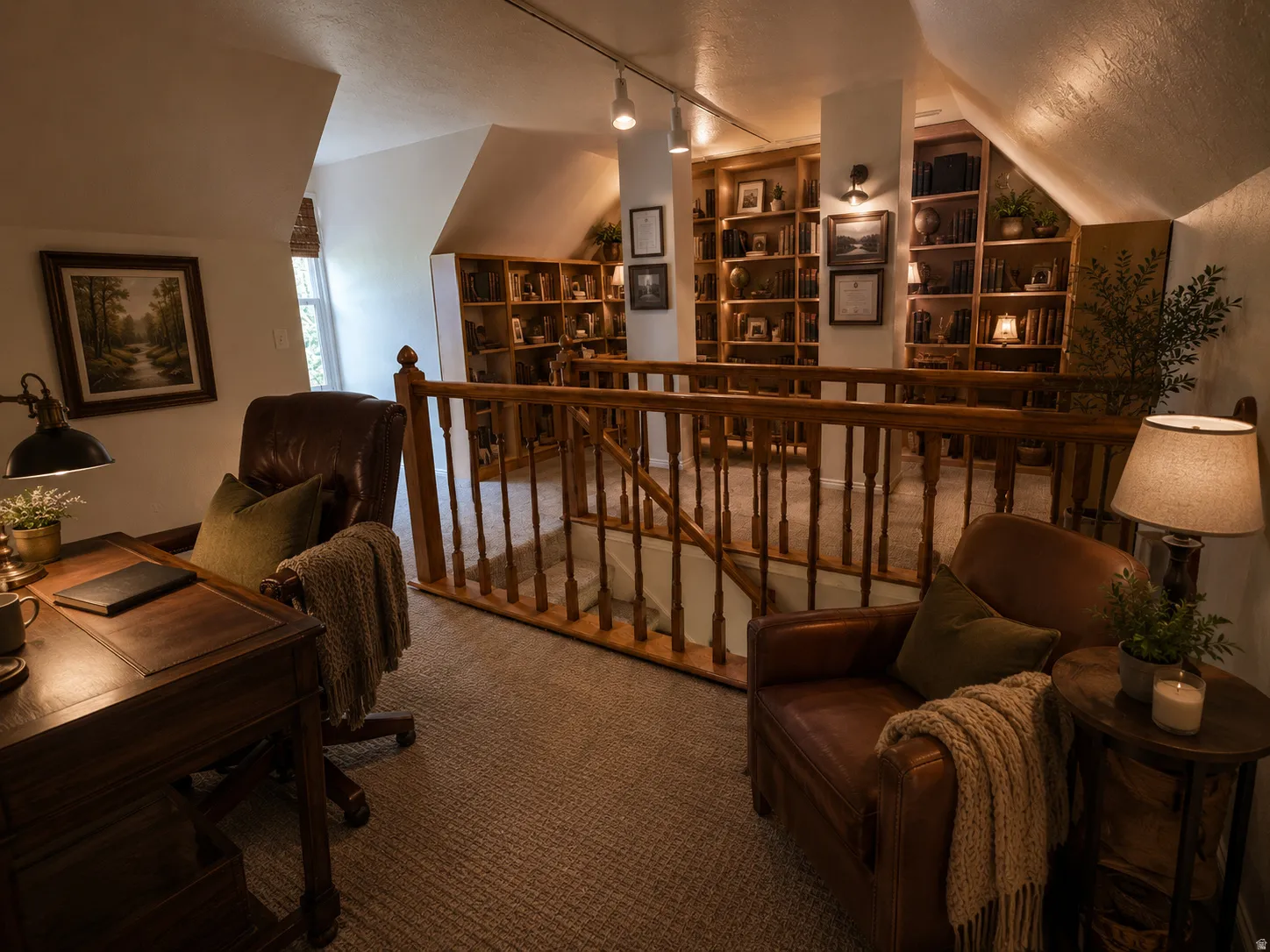 Carpeted loft area featuring a wood baluster railing, built-in shelving, vaulted ceilings, and track lighting