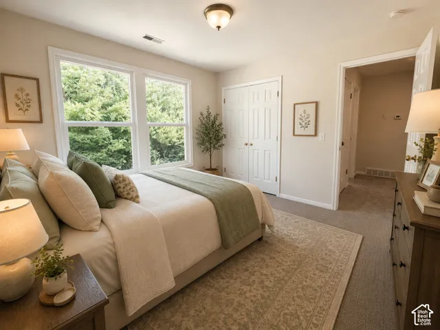 Bright room featuring large windows, neutral-toned walls, and soft carpet flooring