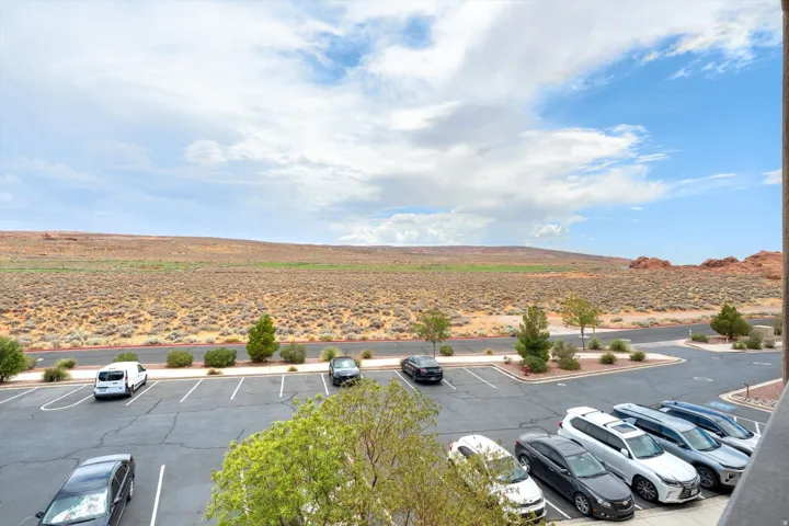 Expansive desert landscape under a partially clouded sky