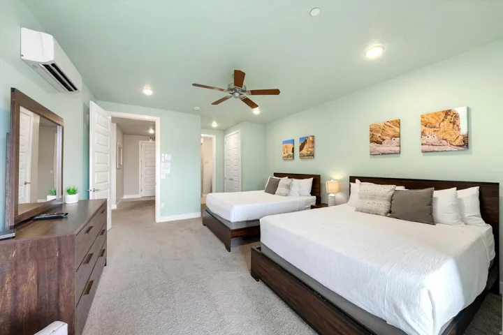 Spacious room featuring light green walls and plush carpet flooring