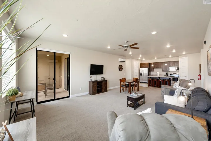 Open-concept living space with recessed lighting and a ceiling fan