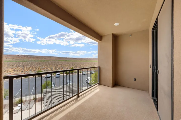 Outdoor balcony featuring a metal railing and a desert landscape backdrop