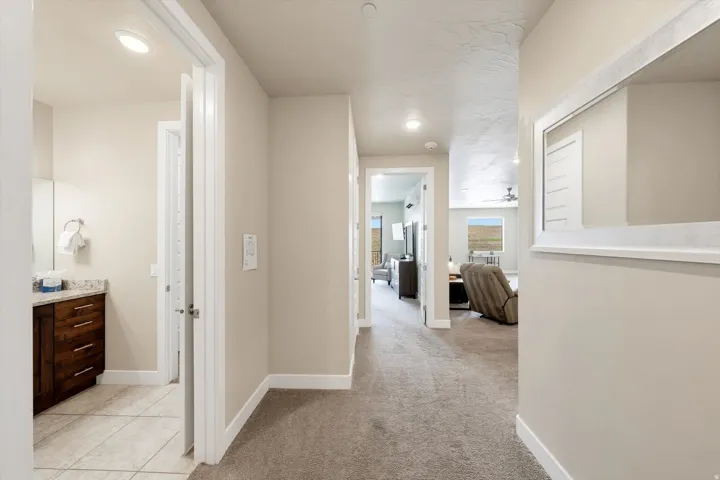 Hallway featuring neutral-toned carpet flooring, recessed lighting, and white baseboards